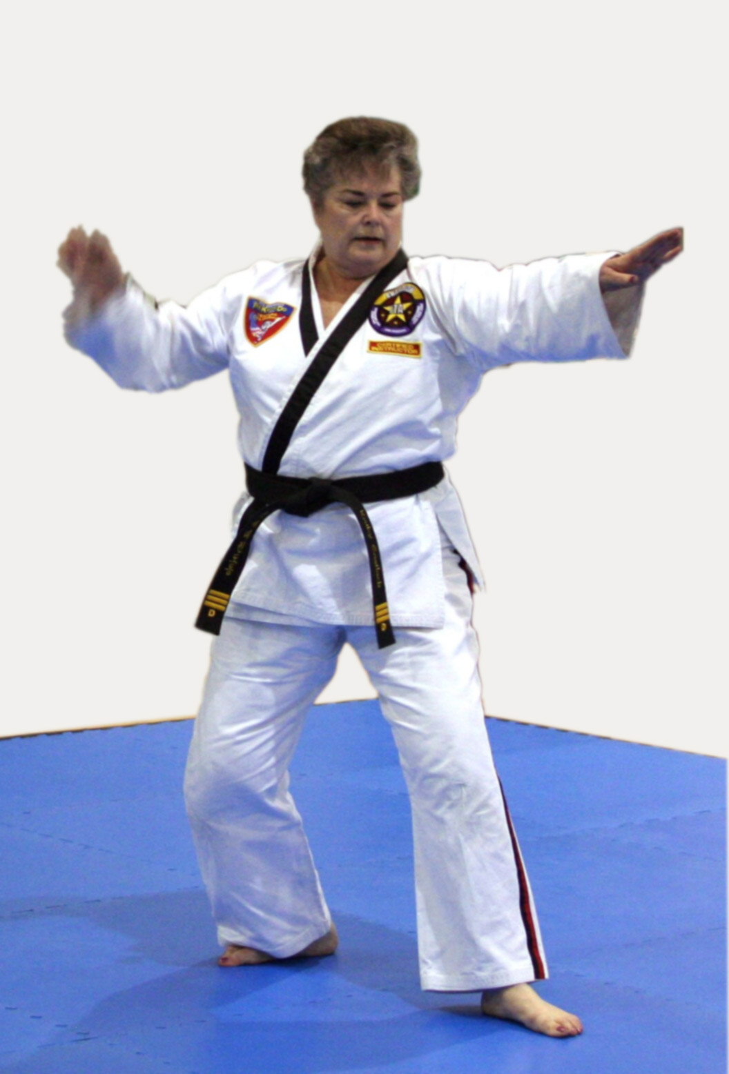 Adult black belt competing with her form at a tournament