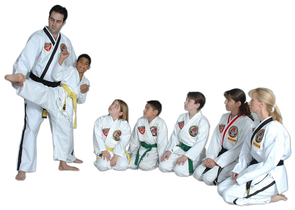TaeKwonDo Masters Mike and Lyn Cerminaro demonstrating a sidekick to a group of students